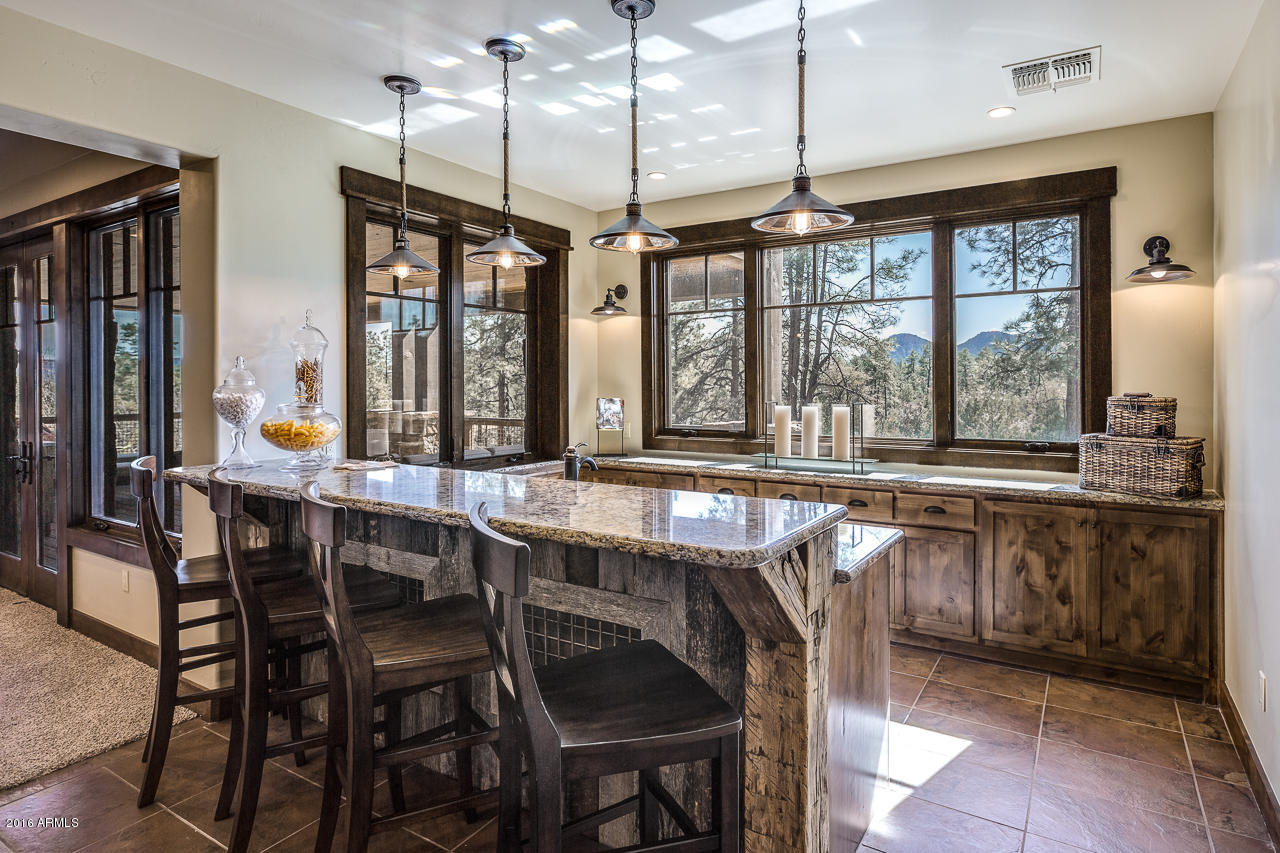 3003 East Arrow Point Payson, AZ 85541 - Photo 15 of 36 a kitchen with a table chairs sink and cabinets