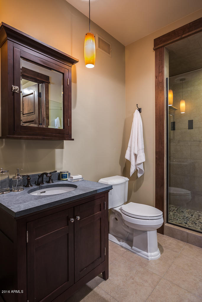 3003 East Arrow Point Payson, AZ 85541 - Photo 22 of 36 a bathroom with a granite countertop toilet sink and mirror