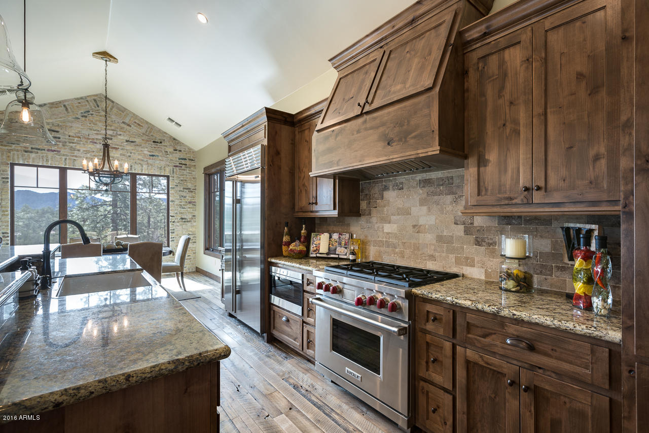 3003 East Arrow Point Payson, AZ 85541 - Photo 5 of 36 a kitchen with stainless steel appliances granite countertop a stove a sink dishwasher and cabinets with wooden floor