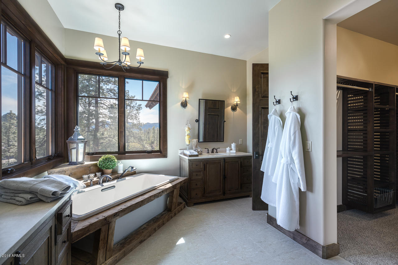 3003 East Arrow Point Payson, AZ 85541 - Photo 9 of 36 a spacious bathroom with a double vanity sink and a window