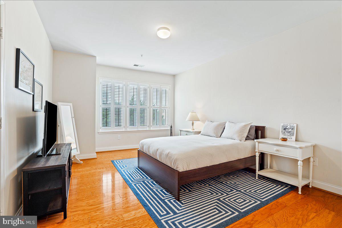 2250 Bear Den Road, Unit 313 Frederick, MD 21701 - Photo 15 of 59 a spacious bedroom with a bed and a flat screen tv