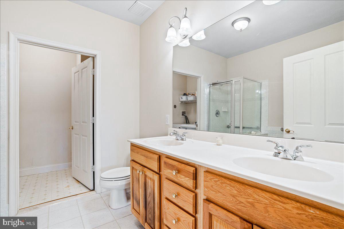 2250 Bear Den Road, Unit 313 Frederick, MD 21701 - Photo 16 of 59 a bathroom with a sink double vanity granite tub and shower