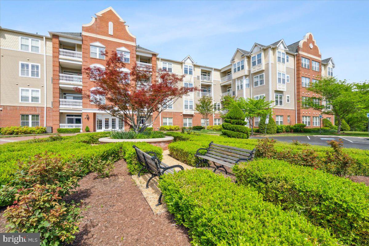2250 Bear Den Road, Unit 313 Frederick, MD 21701 - Photo 30 of 59 a view of a building with a yard