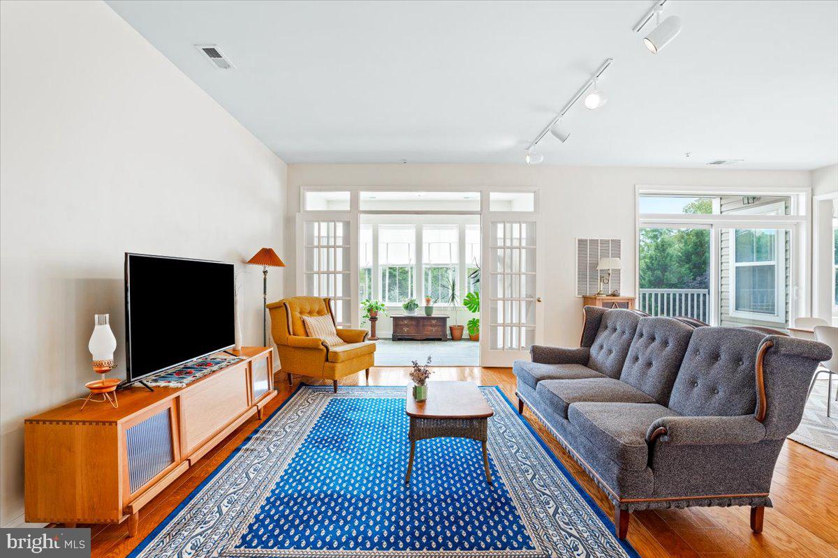2250 Bear Den Road, Unit 313 Frederick, MD 21701 - Photo 3 of 59 a living room with furniture and a flat screen tv