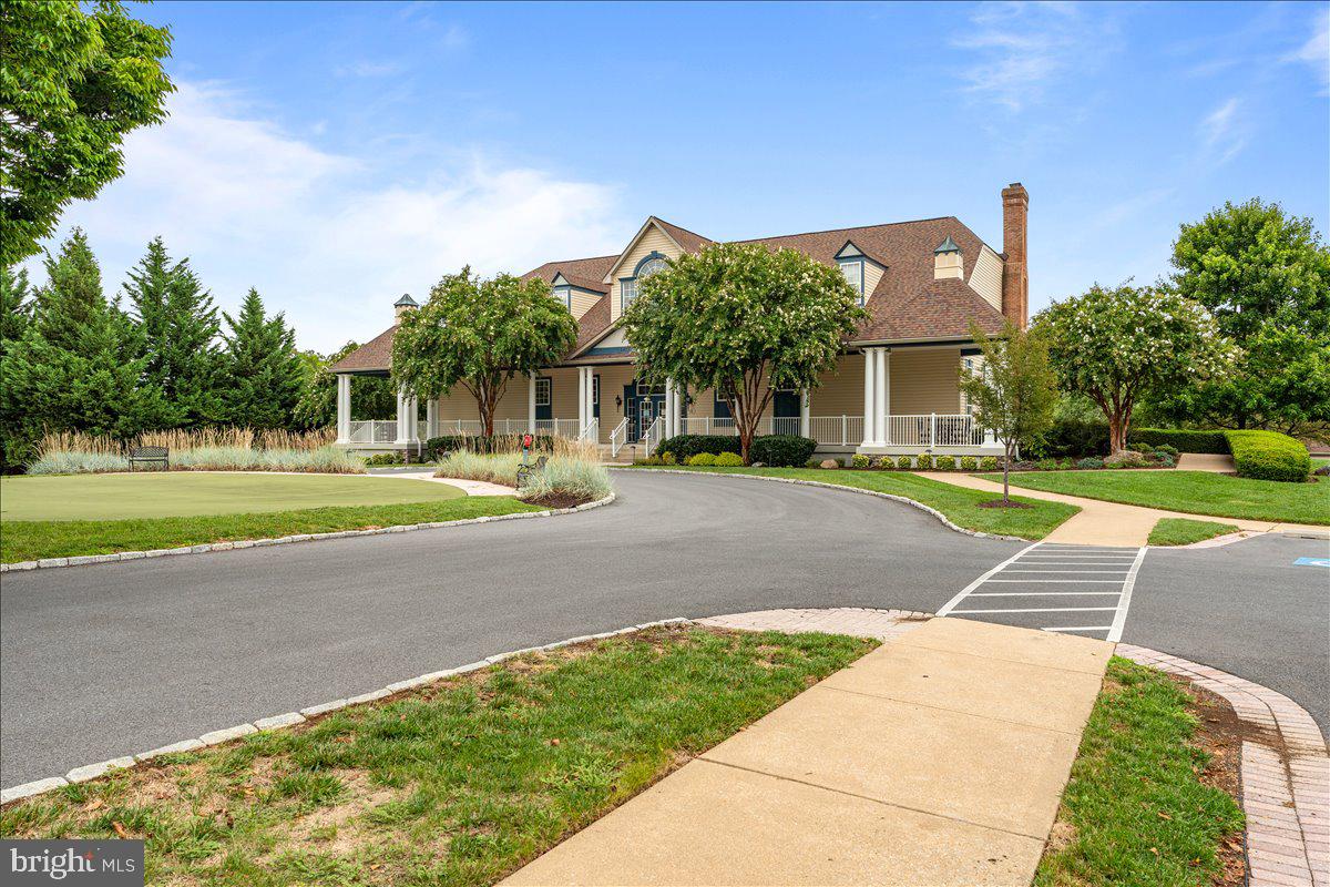 2250 Bear Den Road, Unit 313 Frederick, MD 21701 - Photo 34 of 59 a front view of a house with a yard and trees