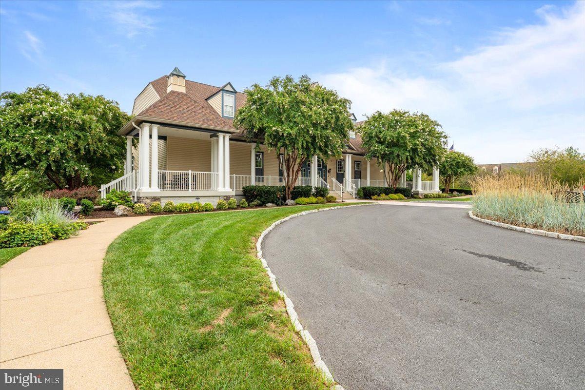 2250 Bear Den Road, Unit 313 Frederick, MD 21701 - Photo 36 of 59 a front view of a house with a yard and potted plants