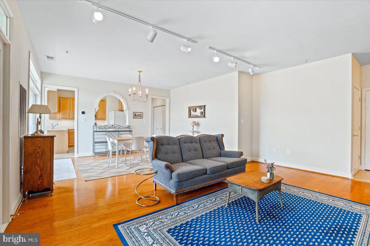 2250 Bear Den Road, Unit 313 Frederick, MD 21701 - Photo 4 of 59 a living room with furniture a rug and a chandelier