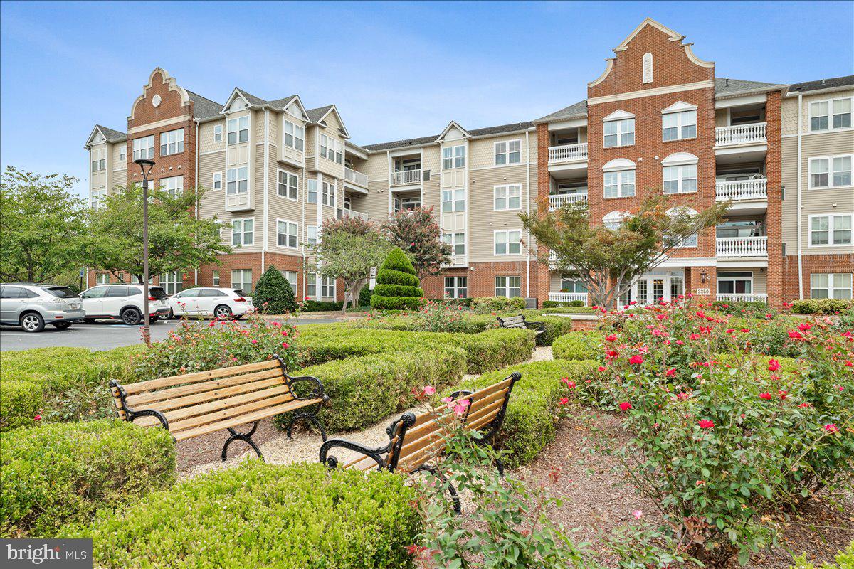 2250 Bear Den Road, Unit 313 Frederick, MD 21701 - Photo 50 of 59 a front view of a residential apartment building with a yard