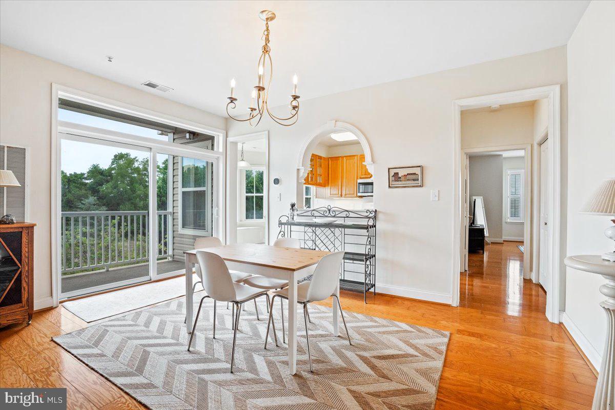 2250 Bear Den Road, Unit 313 Frederick, MD 21701 - Photo 7 of 59 a view of a dining room with furniture window and wooden floor