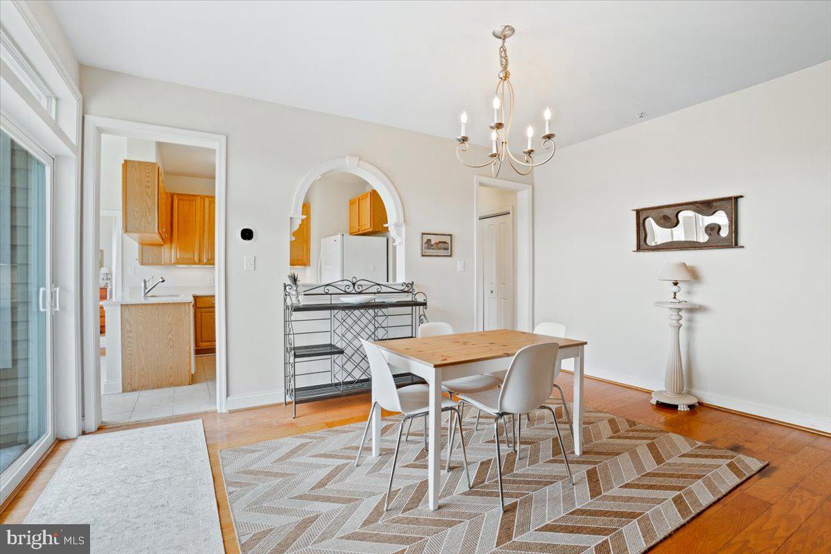 2250 Bear Den Road, Unit 313 Frederick, MD 21701 - Photo 8 of 59 a view of a dining room with furniture and chandelier