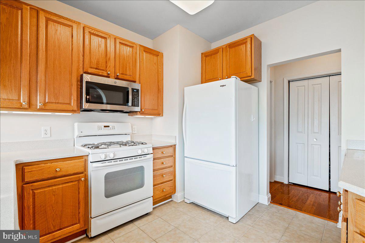 2250 Bear Den Road, Unit 313 Frederick, MD 21701 - Photo 10 of 59 a kitchen with a refrigerator stove and microwave