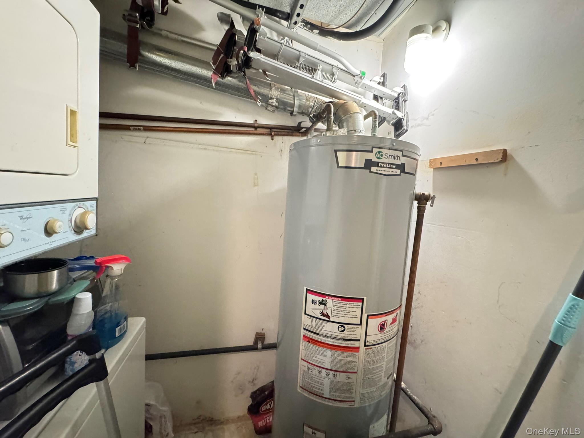 104-21 39th Avenue, Unit 211C Queens, NY 11368 - Photo 13 of 15 a utility room with dryer and washer