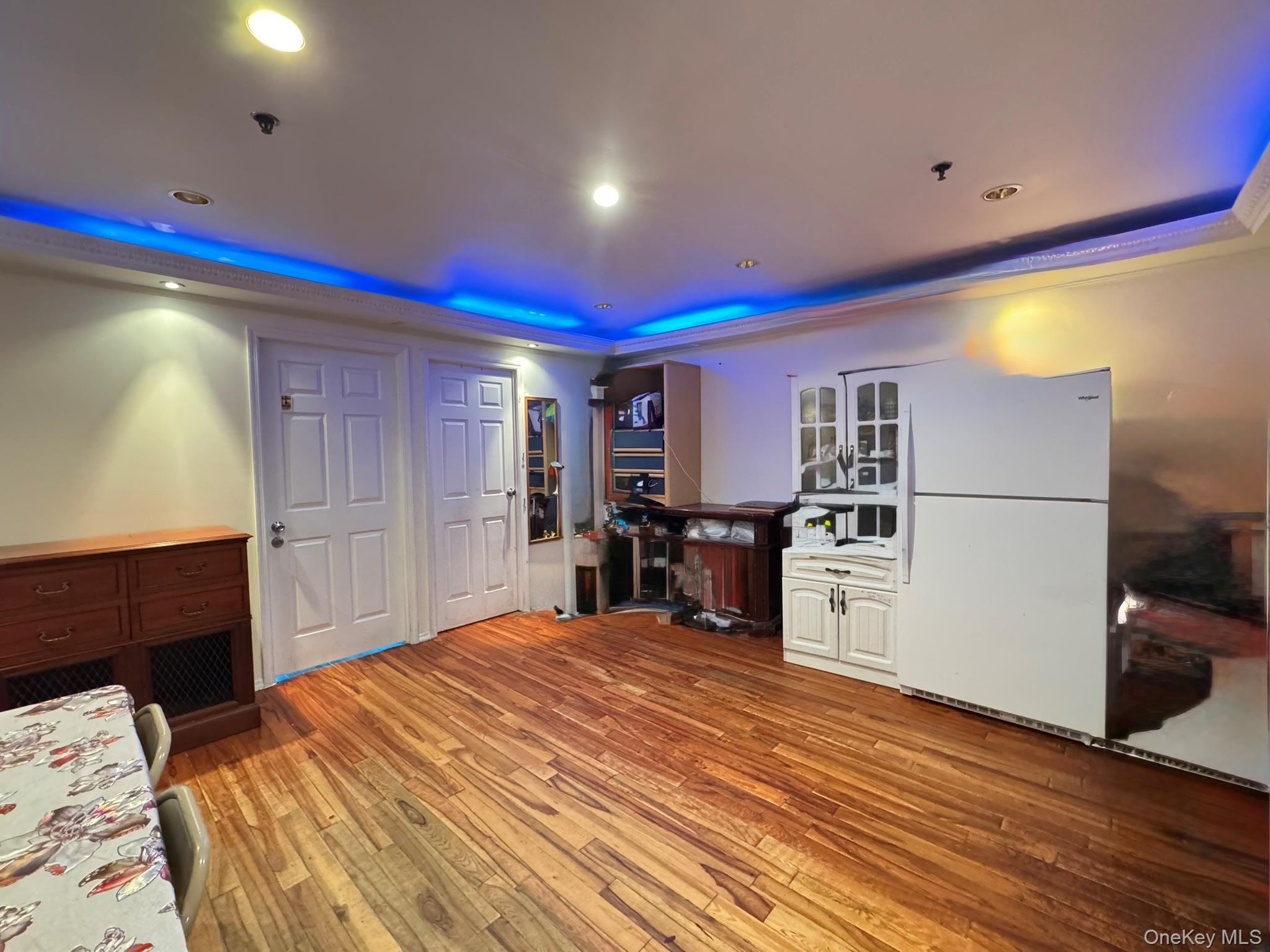 104-21 39th Avenue, Unit 211C Queens, NY 11368 - Photo 4 of 15 a bed room with a bed and a television