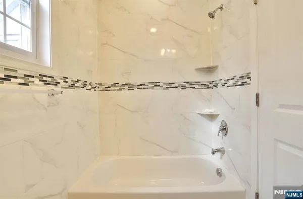 a bathroom with a shower and a tub