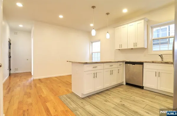 a kitchen with white cabinets and white appliances
