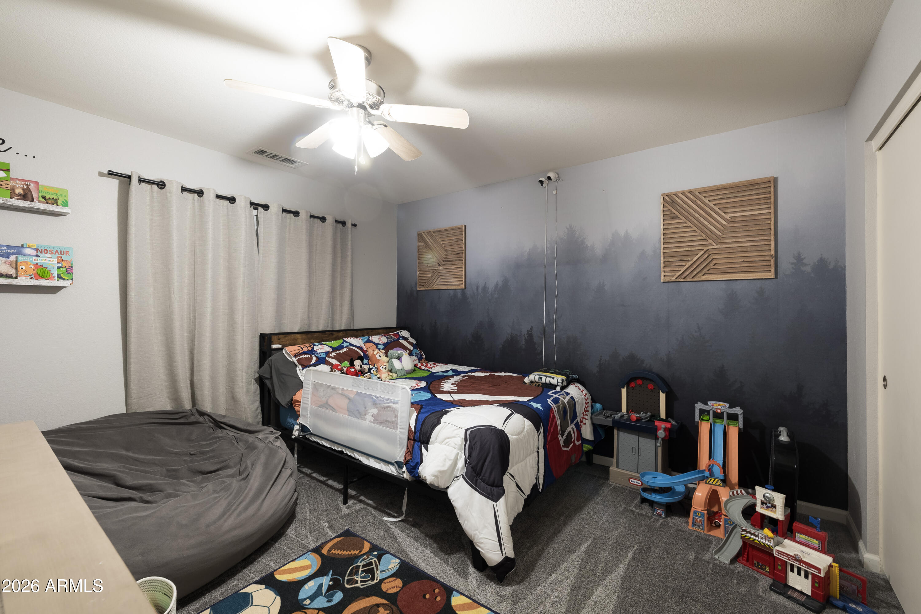 6407 West Saddlehorn Road Phoenix, AZ 85083 - Photo 30 of 41 a bedroom with a bed and a chandelier