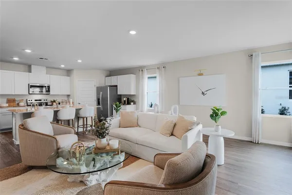 a living room with furniture kitchen and kitchen view