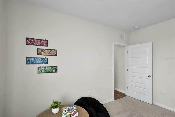 a bedroom with a bed and painting on the wall