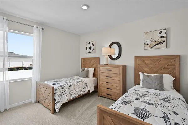 a bedroom with a bed and cabinet