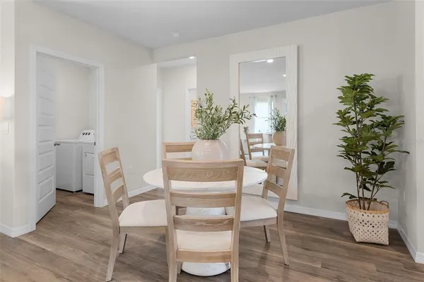 a dining room with furniture and wooden floor
