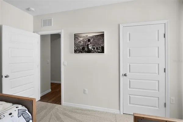 a bedroom with a bed and a closet