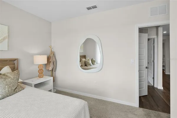 a bedroom with a bed and a painting on the wall