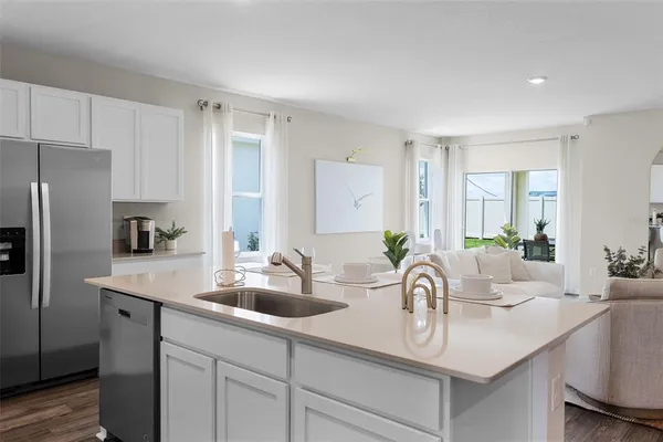 a kitchen with refrigerator and a sink
