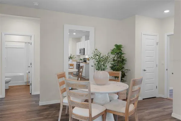 a view of a dining room with furniture and wooden floor