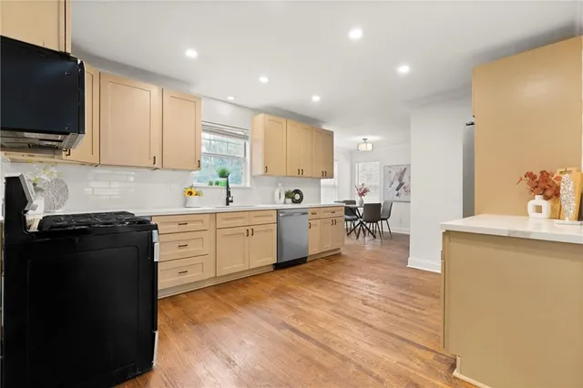 a kitchen with a sink cabinets and window