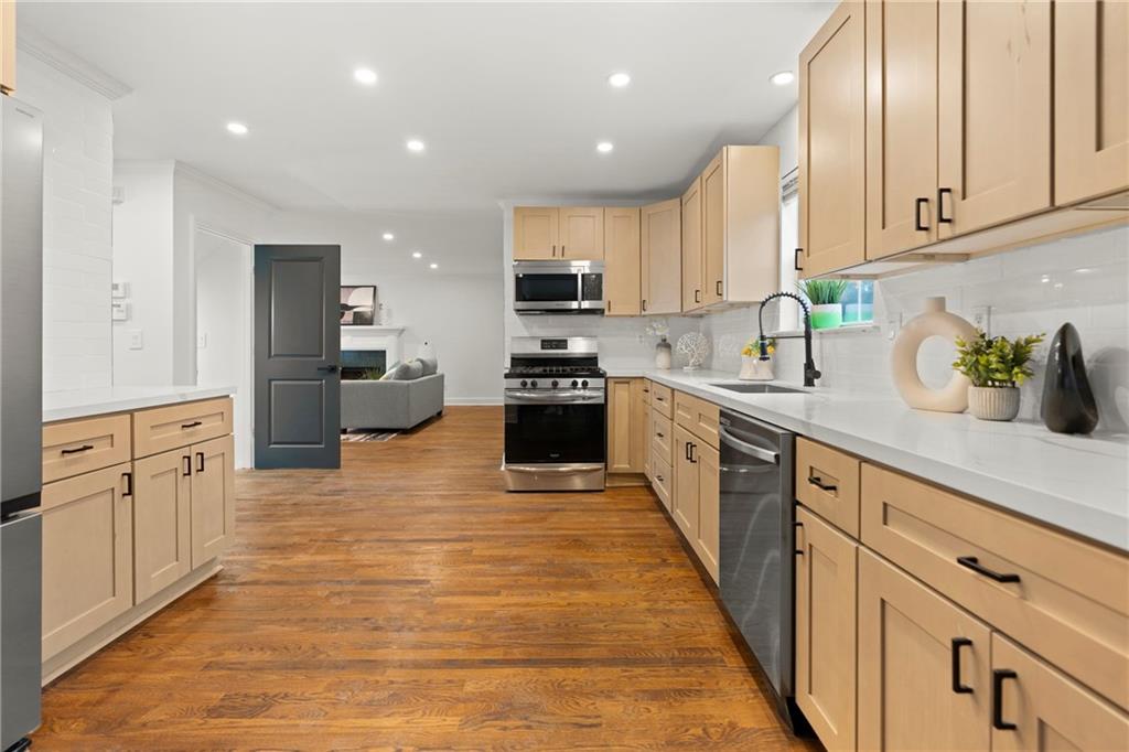 560 Flowering Trail Grayson, GA 30017 - Photo 14 of 68 a large kitchen with stainless steel appliances granite countertop a stove a sink and a refrigerator