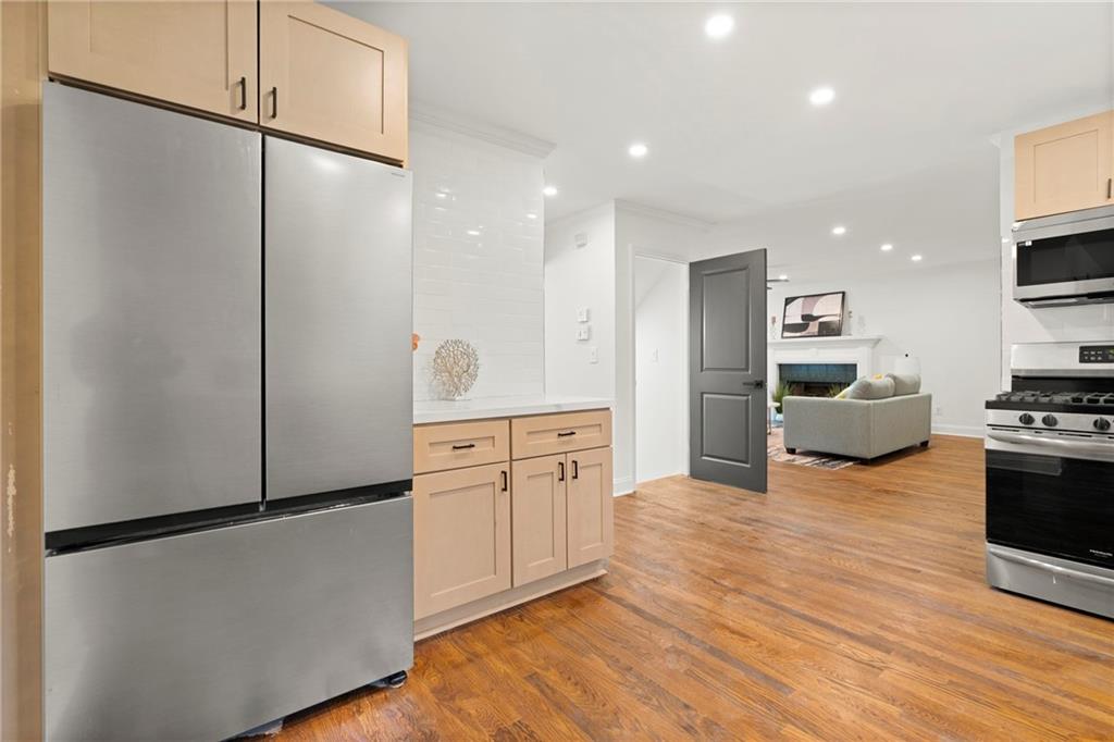 560 Flowering Trail Grayson, GA 30017 - Photo 15 of 68 a kitchen with stainless steel appliances a refrigerator sink and stove