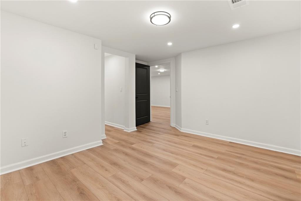 560 Flowering Trail Grayson, GA 30017 - Photo 22 of 68 an empty room with wooden floor and natural light