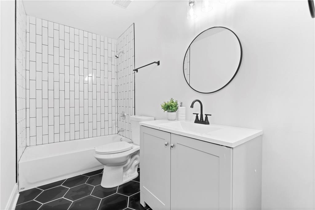 560 Flowering Trail Grayson, GA 30017 - Photo 24 of 68 a bathroom with a sink toilet and a mirror
