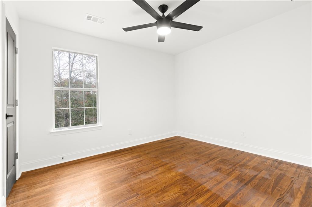 560 Flowering Trail Grayson, GA 30017 - Photo 25 of 68 wooden floor in an empty room with a window