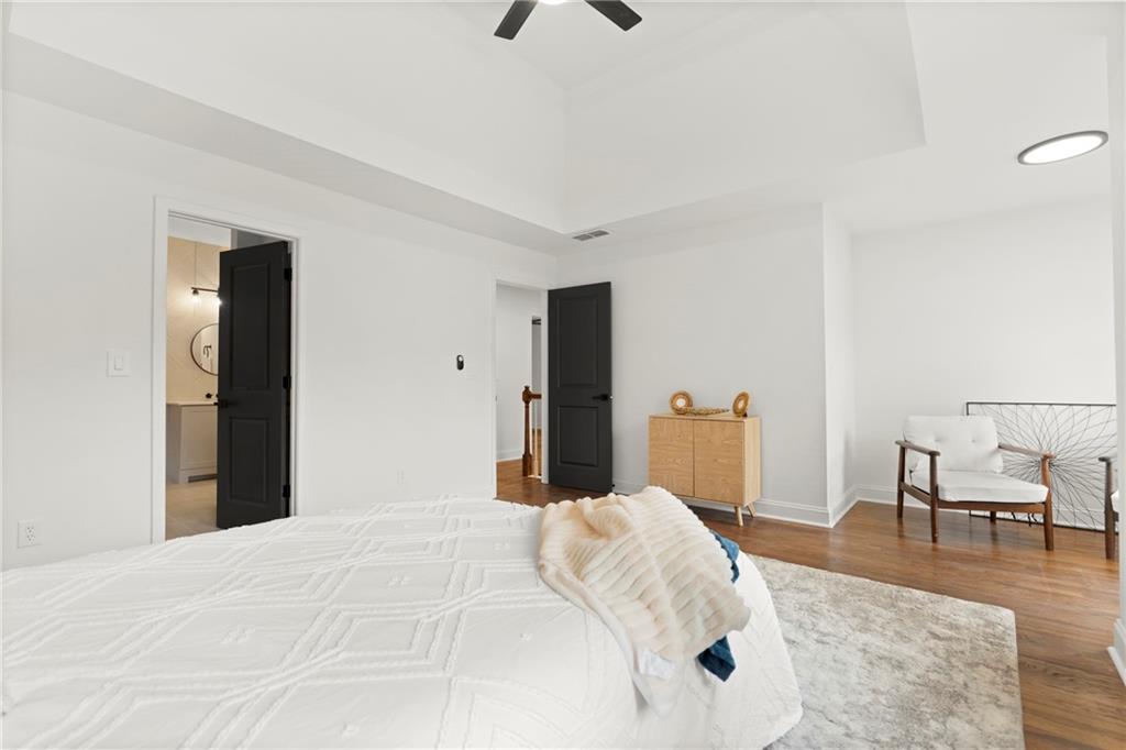 560 Flowering Trail Grayson, GA 30017 - Photo 28 of 68 a bedroom with a bed and wooden floor