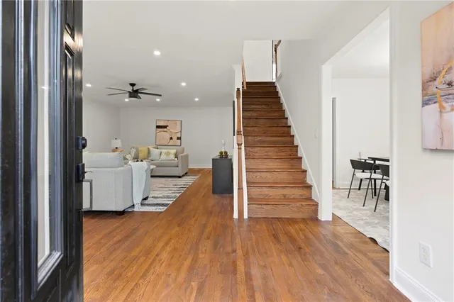 a view of a room with wooden floor and stairs