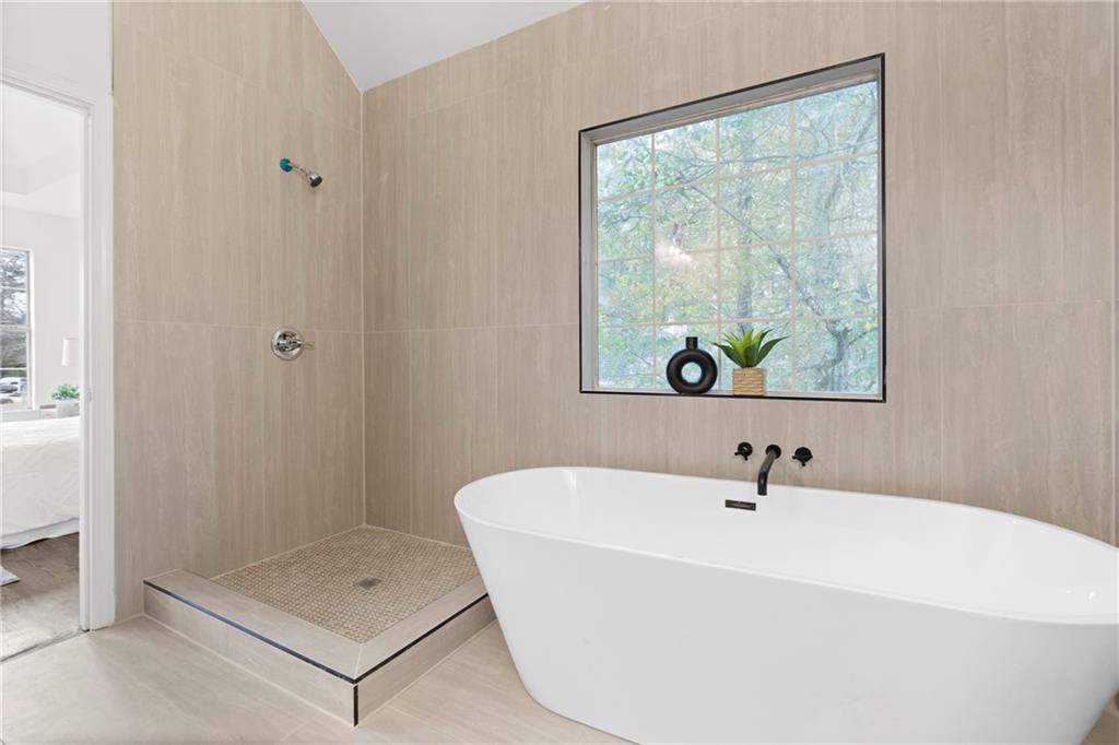 560 Flowering Trail Grayson, GA 30017 - Photo 31 of 68 a bathroom with a tub and a sink