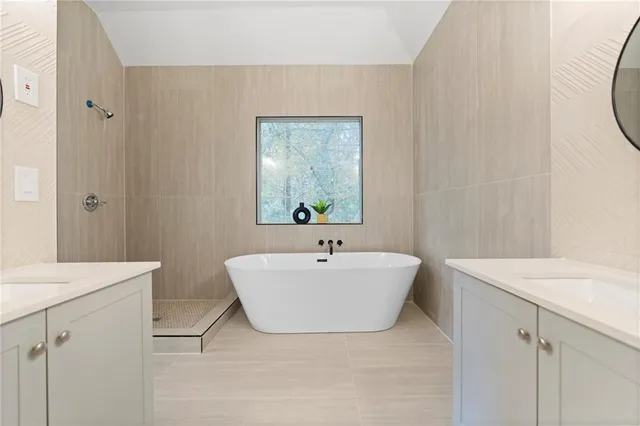 a view of an empty room with wooden floor and white walls