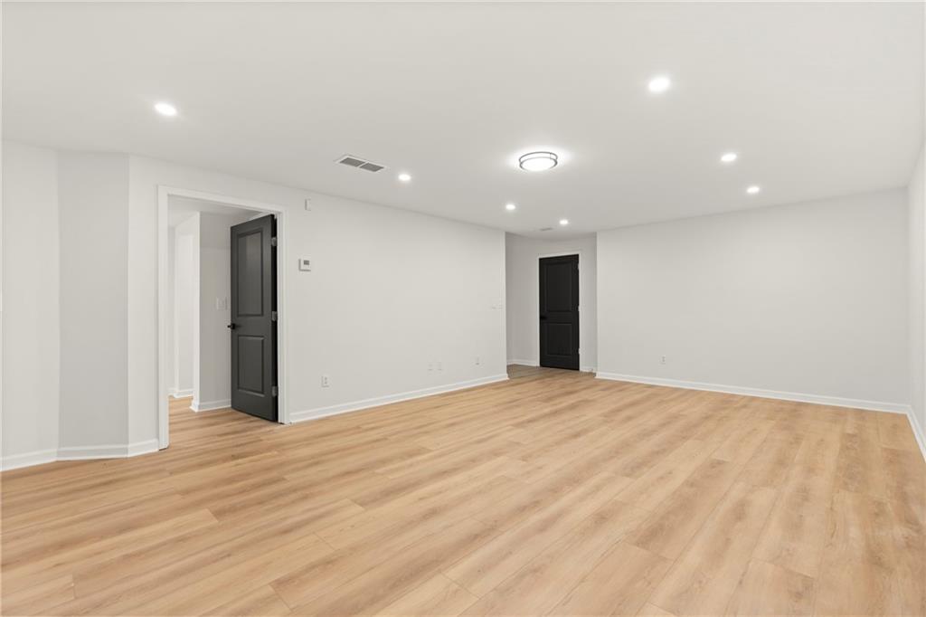 560 Flowering Trail Grayson, GA 30017 - Photo 42 of 68 a view of an empty room with wooden floor