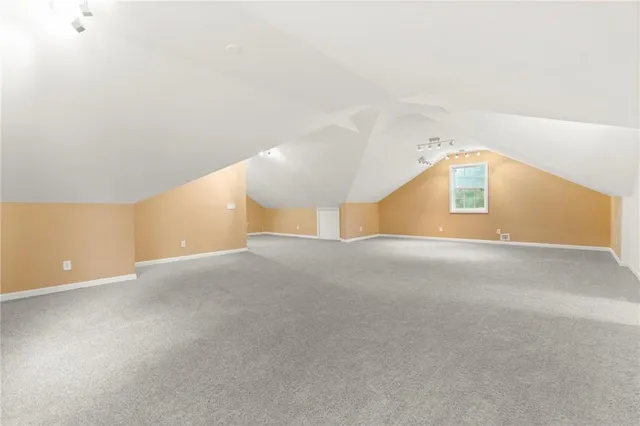 a view of a house with a yard and large trees