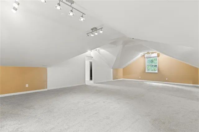 a view of a house with a yard and wooden fence