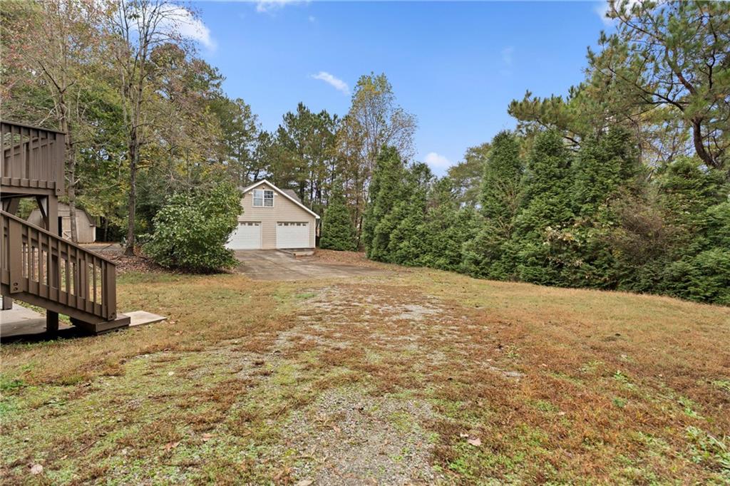 560 Flowering Trail Grayson, GA 30017 - Photo 59 of 68 a view of a house with a yard and wooden fence