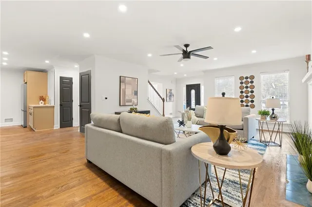 a living room with furniture and wooden floor