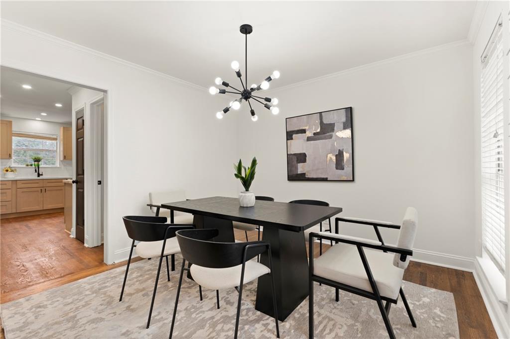 560 Flowering Trail Grayson, GA 30017 - Photo 8 of 68 a view of a dining room with furniture and a chandelier