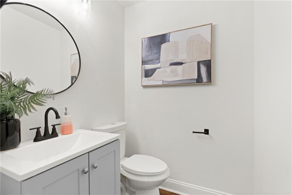 560 Flowering Trail Grayson, GA 30017 - Photo 10 of 68 a bathroom with a toilet sink and mirror