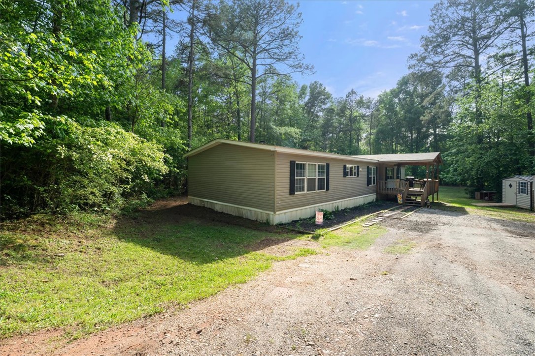 616 Anderson Road Pendleton, SC 29670 - Photo 20 of 29 This tranquil property features a well-maintained residence nestled among lush greenery and towering trees.