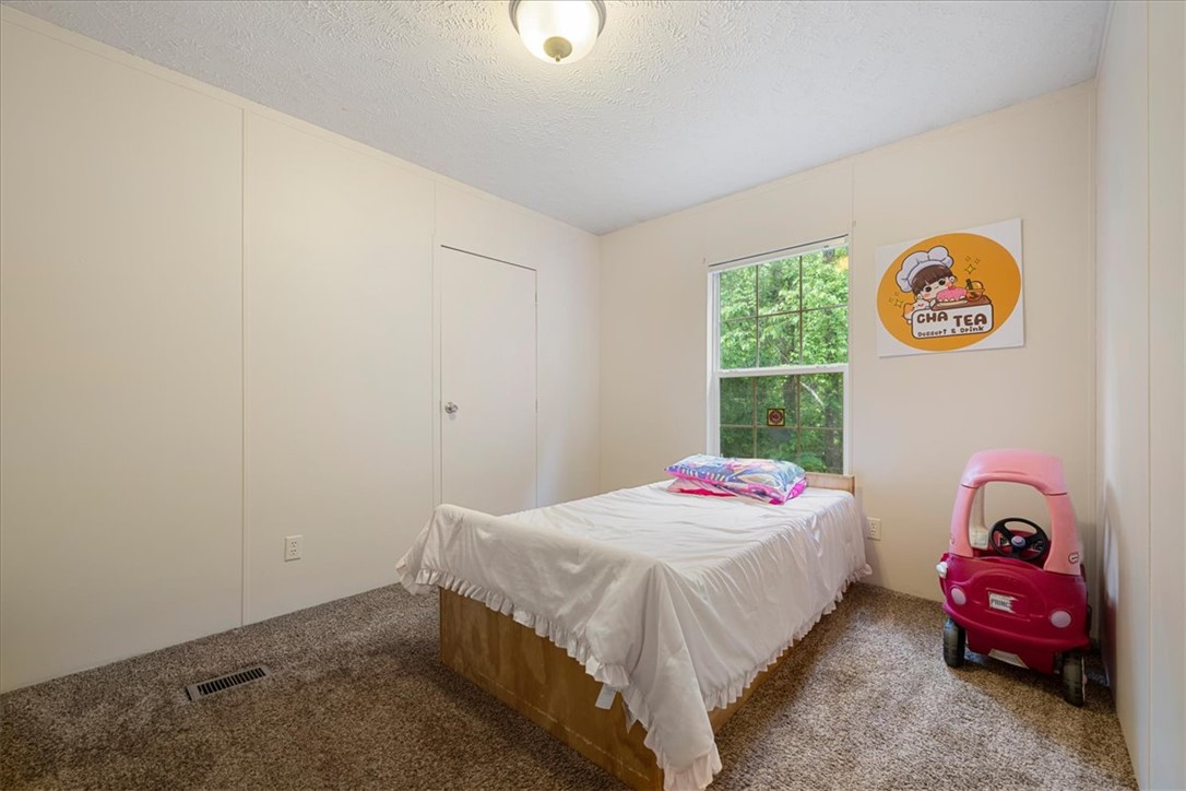 616 Anderson Road Pendleton, SC 29670 - Photo 27 of 29 This cozy bedroom features a bright window and comfortable carpet flooring, perfect for peaceful rest.