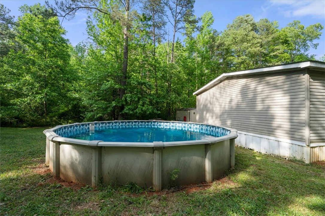 616 Anderson Road Pendleton, SC 29670 - Photo 29 of 29 This private yard features an above-ground pool and ample green space, perfect for outdoor enjoyment.