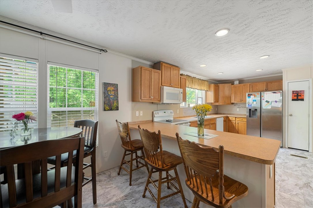 616 Anderson Road Pendleton, SC 29670 - Photo 9 of 29 This spacious kitchen offers ample counter space and a convenient breakfast bar perfect for casual dining.