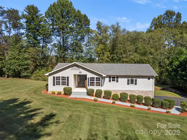 a front view of a house with a yard table and chairs